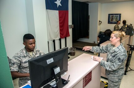 Senior Airmen Dominick Corbin, 502nd Logistics Readiness Squadron, processes Air Force medical personnel from Joint Base San Antonio-Lackland, Texas.
