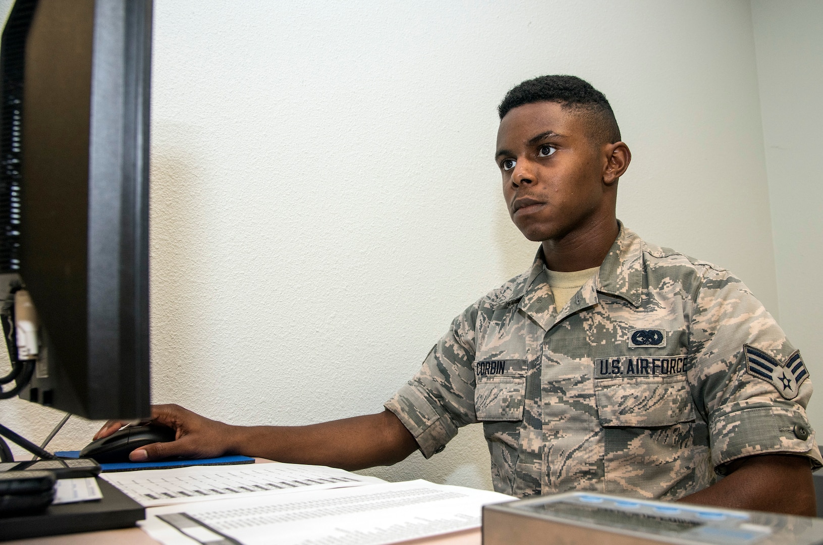 Senior Airmen Dominick Corbin, 502nd Logistics Readiness Squadron, processes Air Force medical personnel from Joint Base San Antonio-Lackland, Texas.