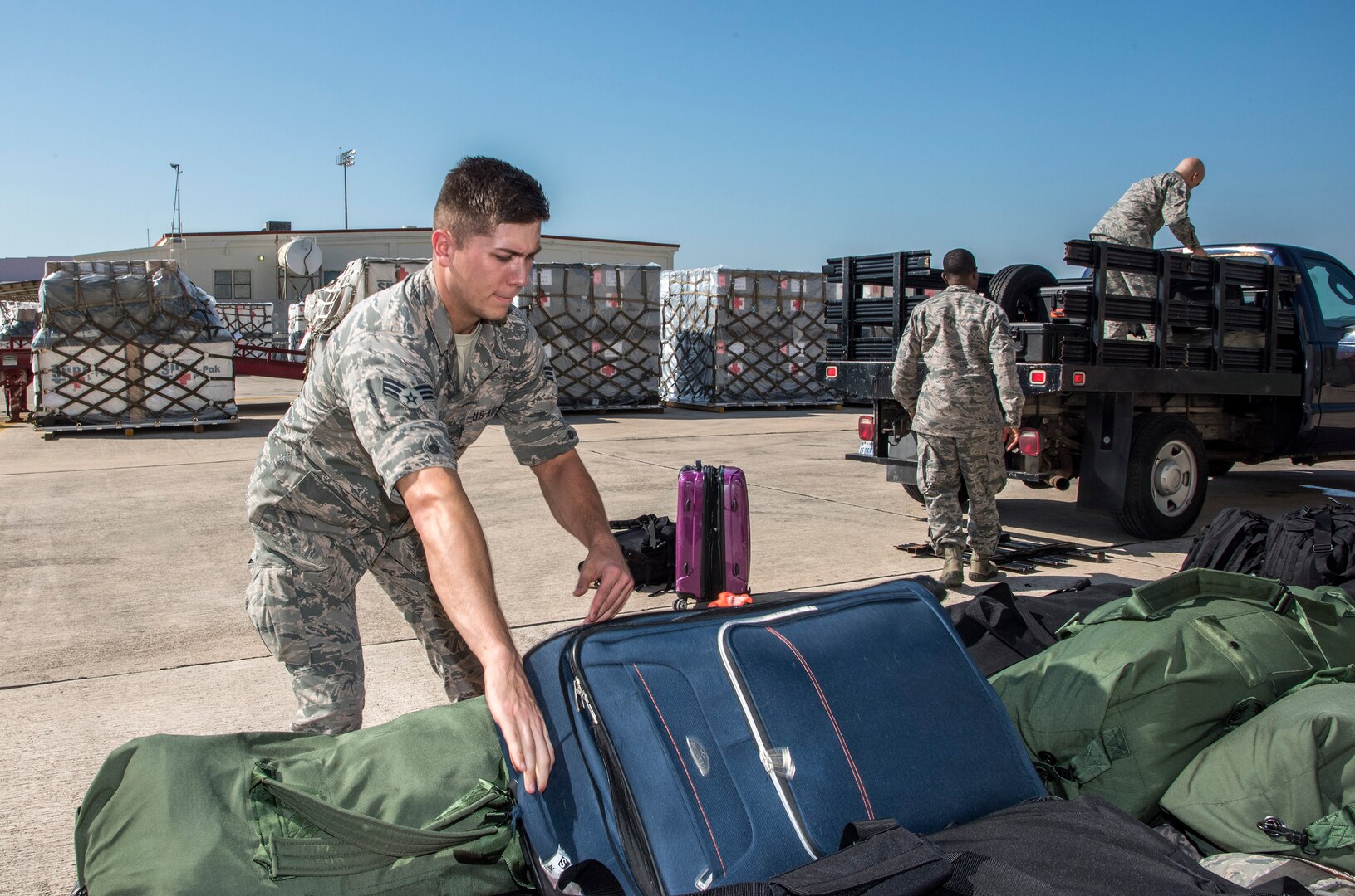 Airmen from the 59th Medical Wing prepare deployment bags for transport Aug. 30, 2017 at Joint Base San Antonio-Lackland, Texas.