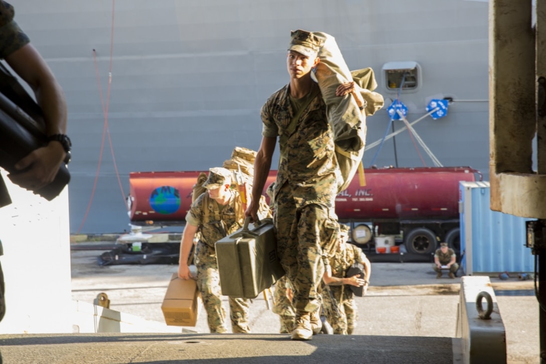 Marines with the 26th Marine Expeditionary Unit, II Marine Expeditionary Force, come aboard the amphibious assault ship USS Kearsarge.