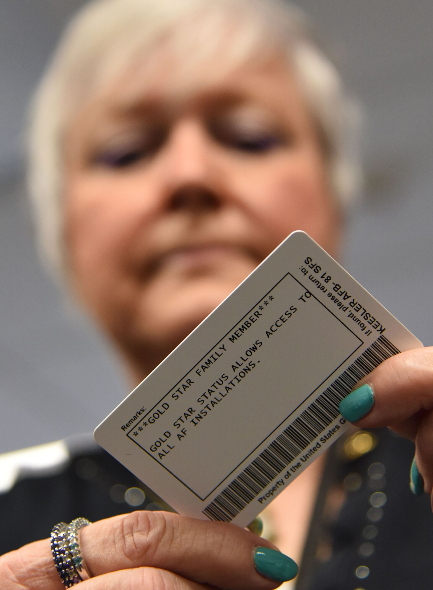 Nora Moore admires her Gold Star Family Member ID card at the visitor center Aug. 29, 2017, on Keesler Air Force Base, Mississippi. As a surviving daughter of a missing in action service member, Moore is allowed to obtain an ID card for recognition and installation access so that she can attend events and access A&FRC referral services. She is Keesler’s first Gold Star Family Member. (U.S. Air Force photo by Kemberly Groue)