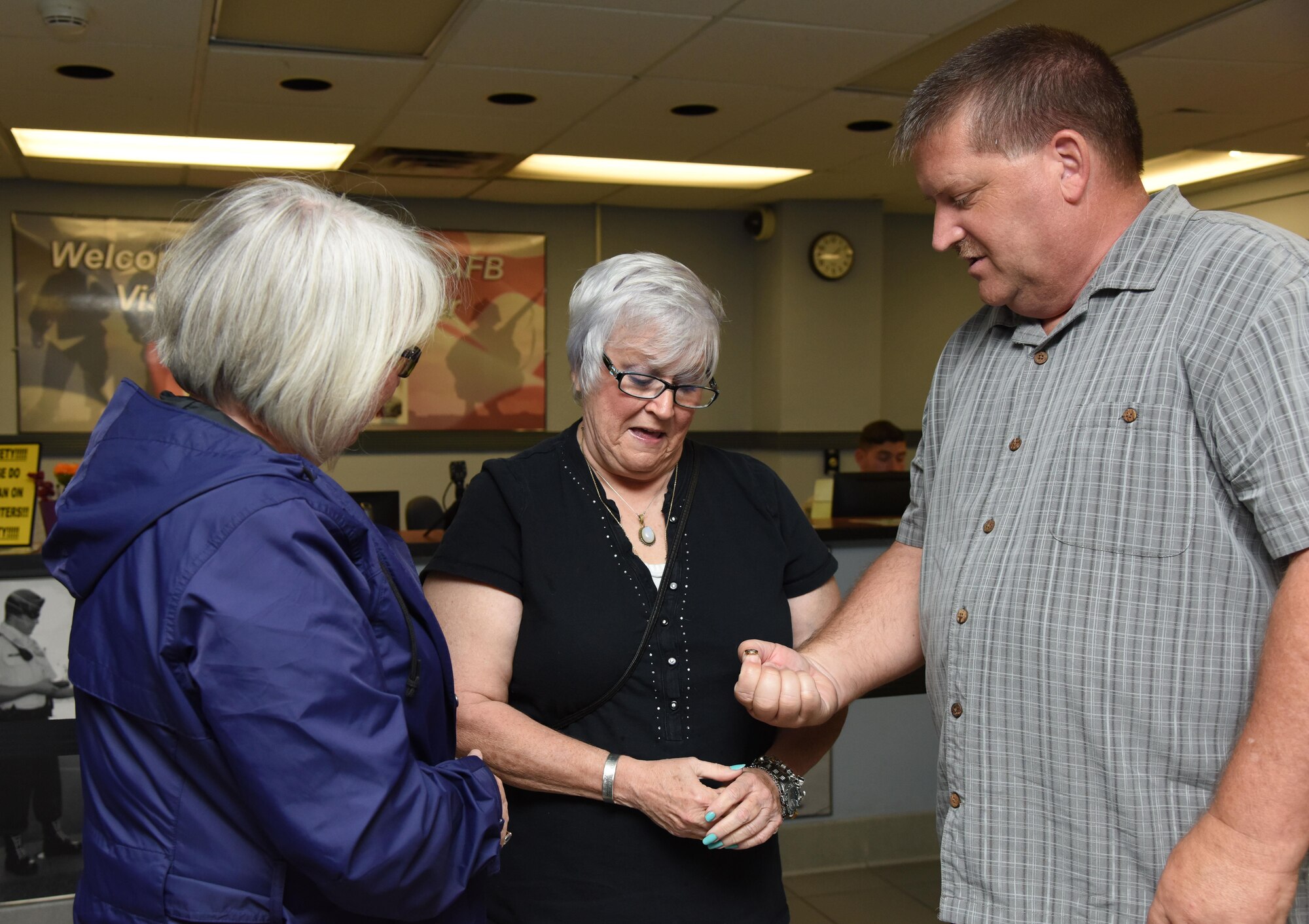 Jackie Pope, 81st Force Support Squadron Airman & Family Readiness Center chief, and John Lowe, 81st FSS community readiness consultant, present Nora Moore with a Gold Star Family Member lapel pin at the visitor center Aug. 29, 2017, on Keesler Air Force Base, Mississippi. As a surviving daughter of a missing in action service member, Moore is allowed to obtain an ID card for recognition and installation access so that she can attend events and access A&FRC referral services. She is Keesler’s first Gold Star Family Member. (U.S. Air Force photo by Kemberly Groue)