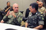Adm. Kurt Tidd (left), commander of U.S. Southern Command, visits with Brazilian Maj. Gen. Jorge Lopes Fossi (right), commander of the PANAMAX 2017 exercise Combined Forces Land Component Command at Joint Base San Antonio-Fort Sam Houston Aug. 15.