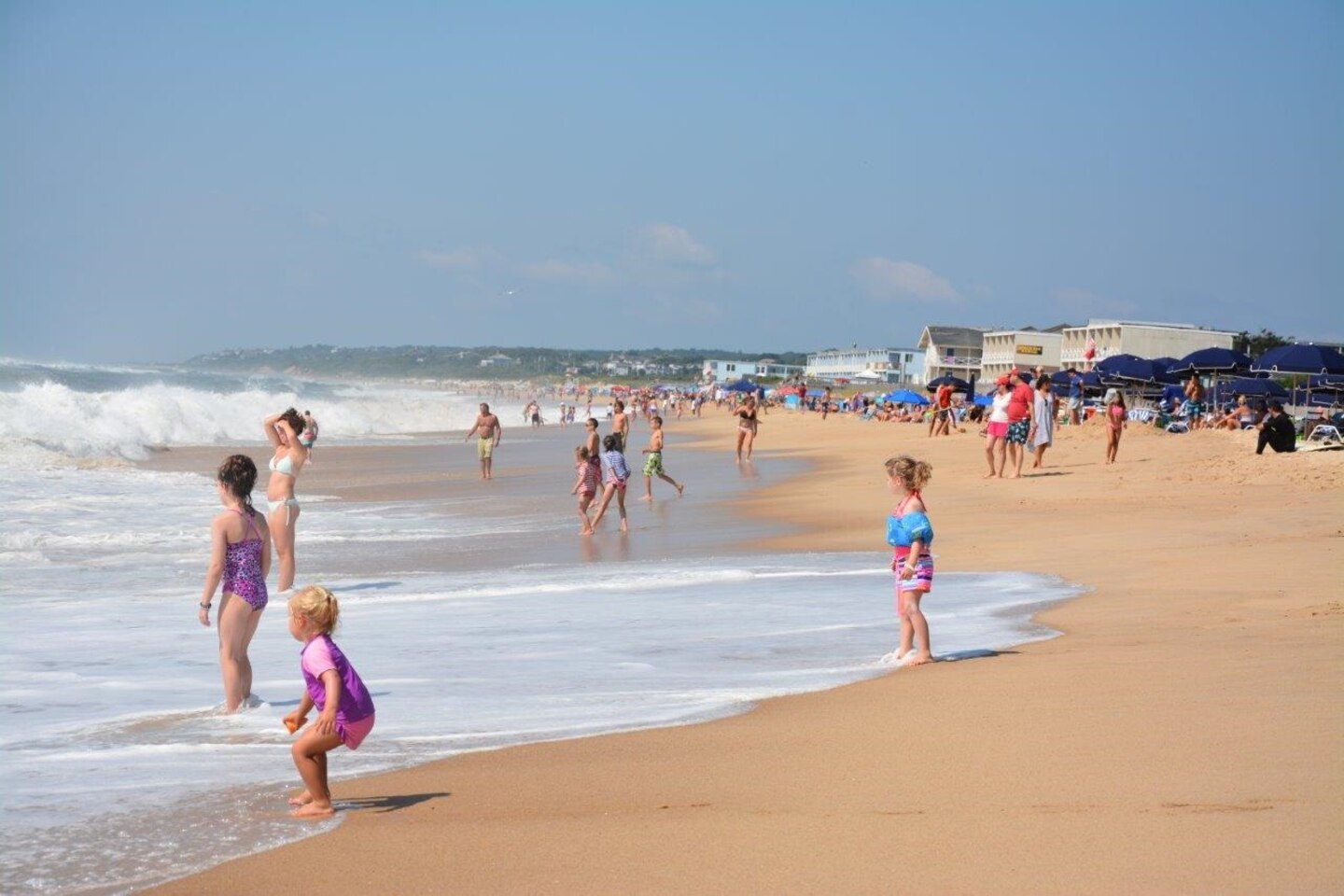 Children enjoy the surf of the Atlantic Ocean in Montauk, New York, August 16,2017. The wider beach is a secondary benefit of a recently-completed flood-control project reducing risk to the community and its residents.