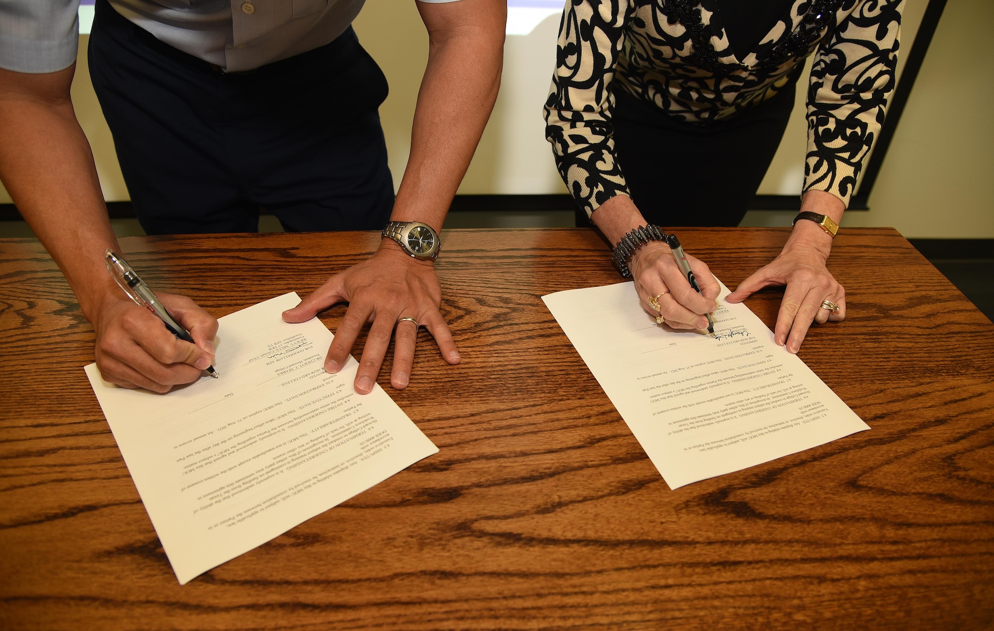 U.S. Air Force Col. Ricky Mills, 17th Training Wing commander, and Dr. Cheryl Sparks, Howard College president, sign a Public-Public and Public-Private memorandum of agreement at the triannual P4 update meeting held at Judge Edd B. Keyes Building in San Angelo, Aug. 31, 2017. The agreement is for Howard College to provide English language skills, high school equivalency in Spanish and life skills training to Goodfellow employees. P4 is a military installation and local community initiative to form partnerships that achieve value and benefit for both. (U.S. Air Force photo by Robert D. Martinez/Released)