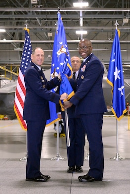 Lt. Gen. Lee K. Levy II, Air Force Sustainment Center commander, passes the guidon to Brig. Gen. Stacey T. Hawkins, incoming Ogden Air Logistics Complex commander, during a change of command ceremony at Hill Air Force Base, Utah, Aug. 31, 2017. (U.S. Air Force photo by Todd Cromar)