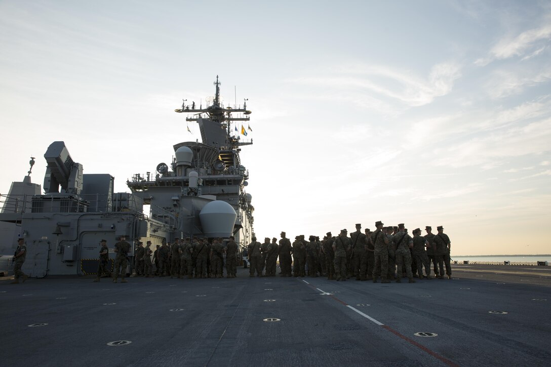 U.S. Marines with the 26th Marine Expeditionary Unit (MEU), II Marine Expeditionary Force, gather on the flight deck of the USS Kearsarge (LHD 3) at Naval Station Norfolk, Va., Aug 30, 2017.