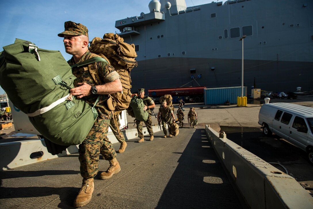 U.S. Marines with the 26th Marine Expeditionary Unit (MEU), II Marine Expeditionary Force, board the USS Keasarge (LHD 3) at Naval Station Norfolk, Va., Aug. 30, 2017.