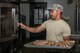U.S. Air Force Airman 1st Class Merwell Magbutay, 20th Force Support Squadron food services journeyman, places Italian sausages in the oven in preparation for lunch at the Chief Master Sgt. Emerson E. Williams Dining Facility at Shaw Air Force Base, S.C., Aug. 31, 2017.