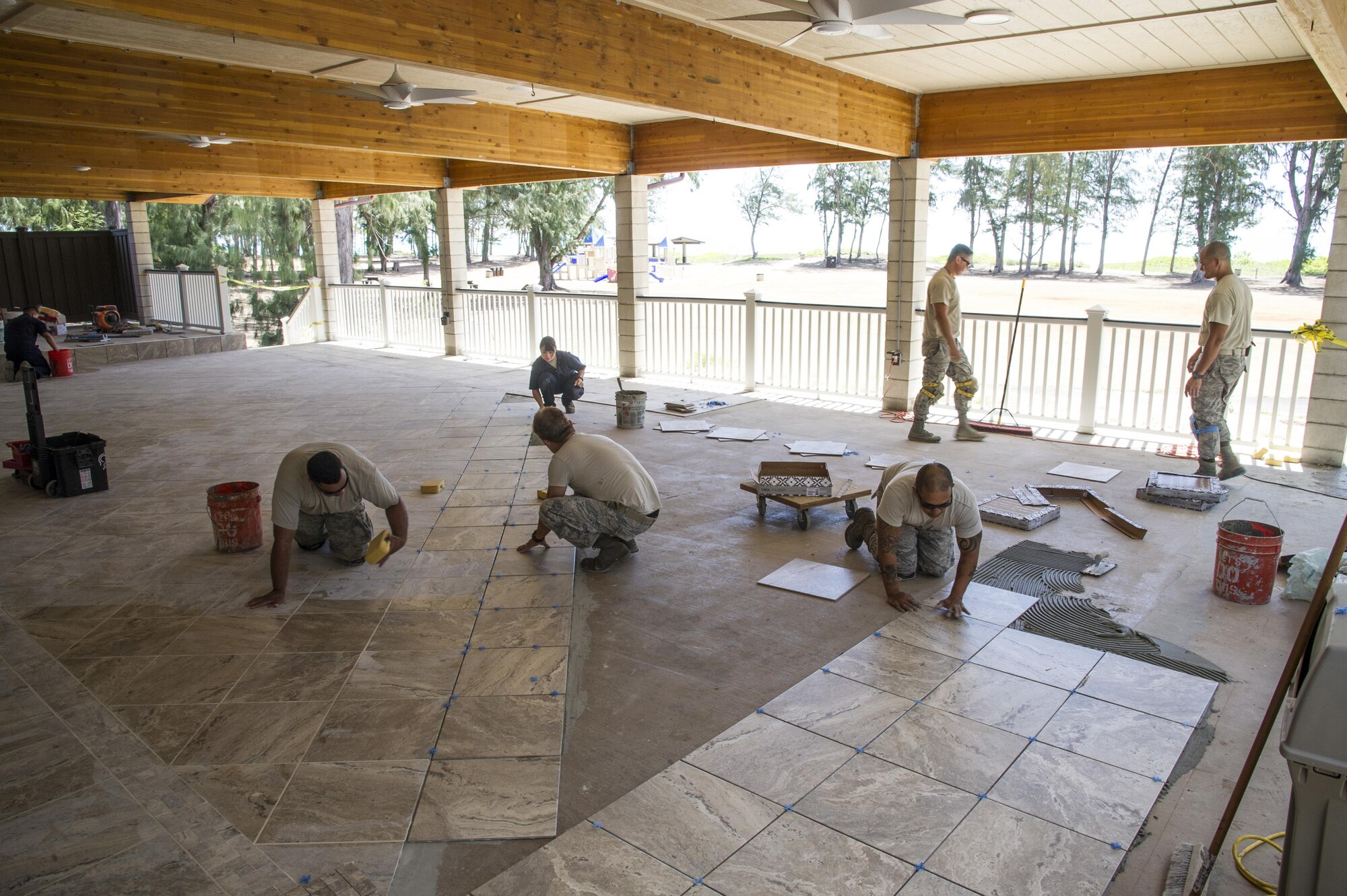 Seven structural engineers with the Air Force Reserve’s 624th Civil Engineer Squadron perfect their engineering skills by installing tile on a 4,500-square-foot lanai for the recreation center at Bellows Air Force Station, Waimanalo, Hawaii, Aug. 25, 2017.