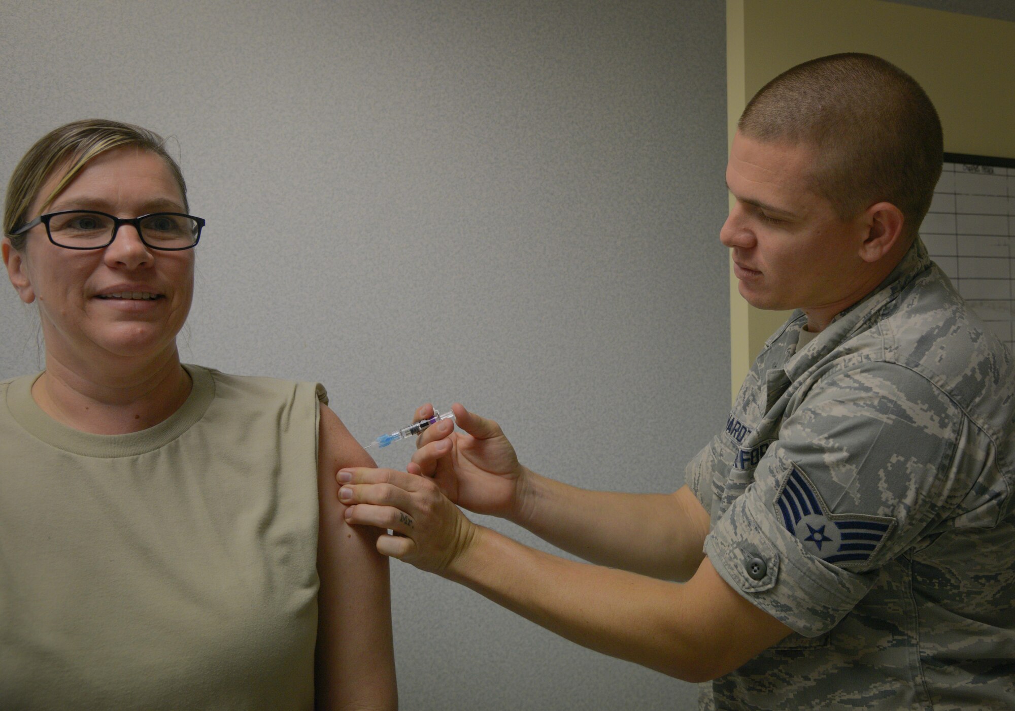 U.S. Air Force Staff Sgt. Justin Everhardt, right, an aerospace medical technician assigned to the 6th Medical Group Brandon Clinic, gives a shot to a patient at the Brandon Clinic, Aug. 30, 2017. The Brandon Clinic serves more than 16,000 people in the area. (U.S. Air Force photo by Senior Airman Mariette Adams)