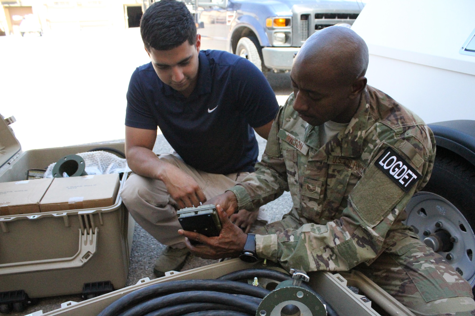 From left, David Rodriguez and Staff Sgt. Dale Wilson, members of the Air Force Security Forces Center Desert Defender Ground Combat Readiness Training Center's Logistics Detail, unpack, inspect and verify equipment before its stored.