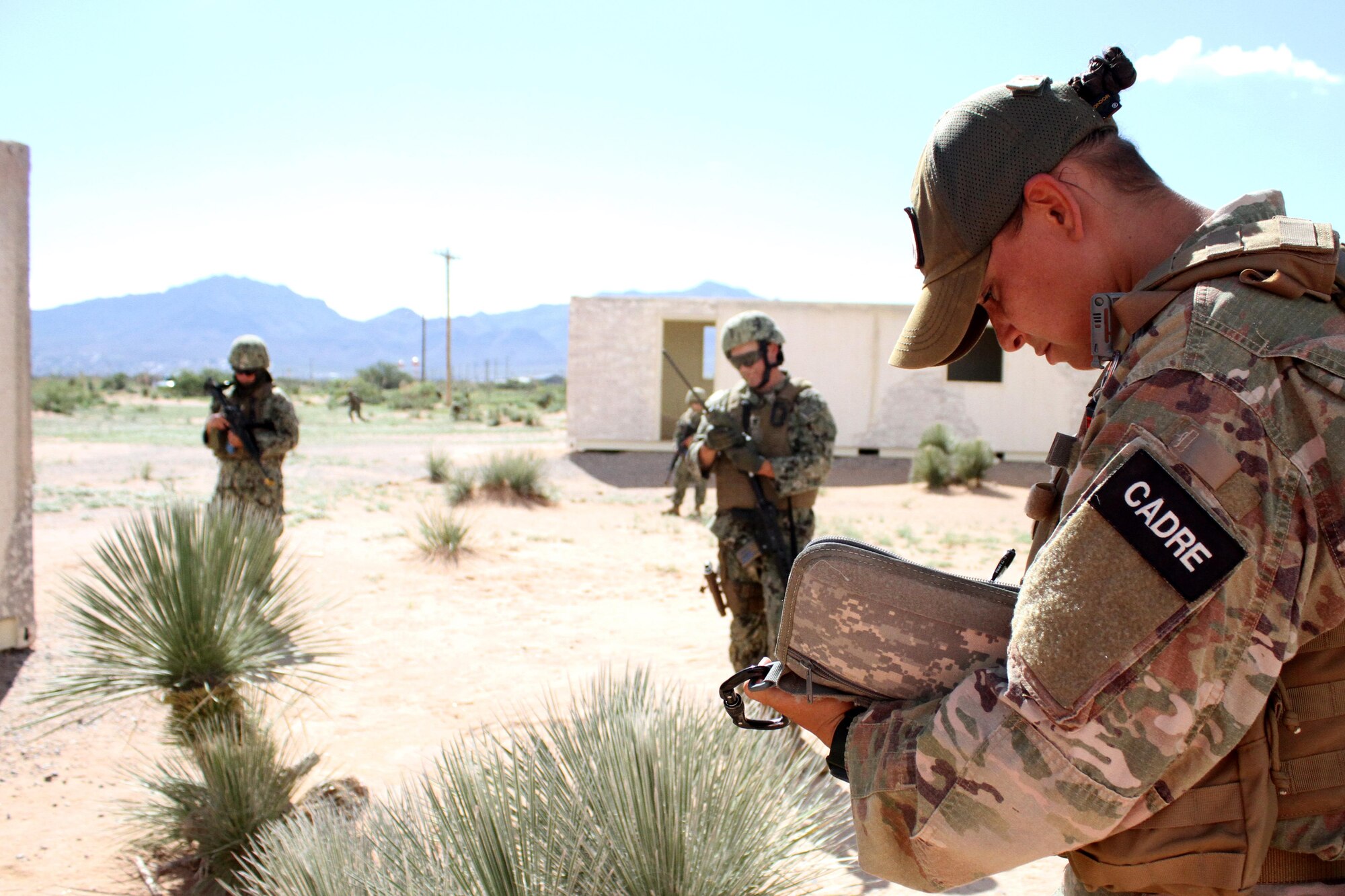 A cadre member evaluates security forces students during a dismounted patrol.