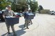 Staff Sgts. Gerard Doran, Jeremy Convery and Jared Shepheard, assigned to 22nd Comptroller Squadron, carry bins of clothing and supplies for Hurricane Harvey victims to a donation point, Aug. 31, 2017, in Wichita, Kan. The items will be transported to a distribution center in Dallas, where they will be given to shelters in need. (U.S. Air Force photo/Staff Sgt. Rachel Waller)