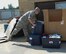 Staff Sgt. Gerard Doran, 22nd Comptroller Squadron quality assurance manager, stacks bins of donations for Hurricane Harvey victims at a donation point, Aug. 31, 2017, in Wichita, Kan. The items will be transported to a distribution center in Dallas, where they will be given to shelters in need. (U.S. Air Force photo/Staff Sgt. Rachel Waller)