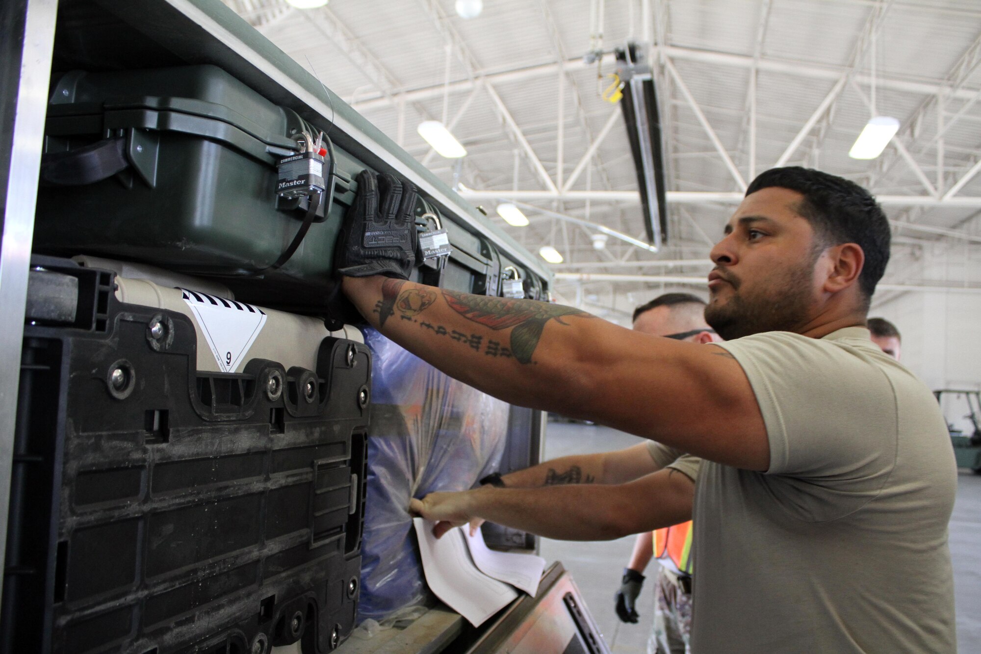 Members of the Air Force Security Forces Center Desert Defender Ground Combat Readiness Training Center's Logistics Detail prepare equipment to send to Defenders downrange.