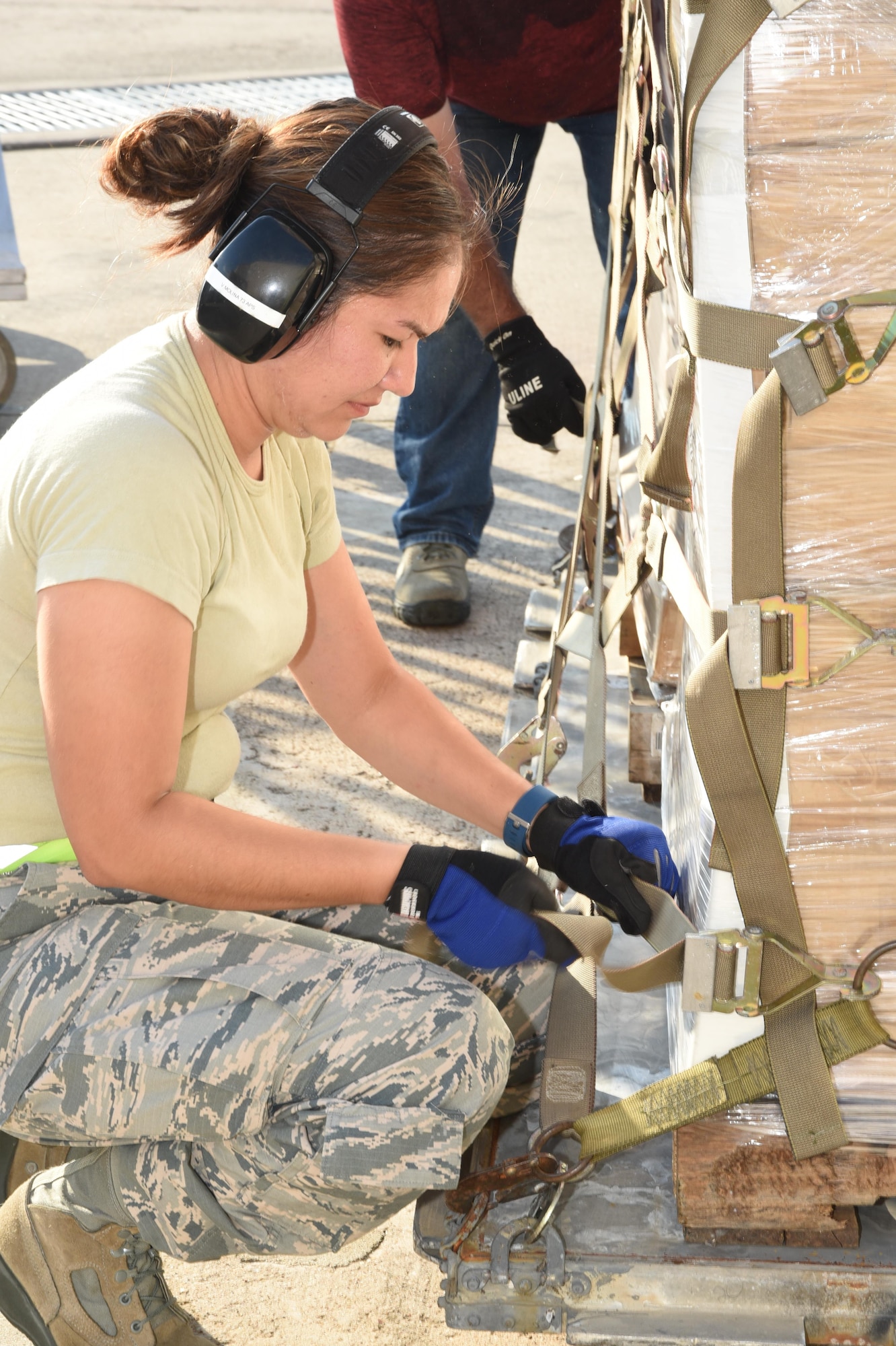 Air Force Master Sgt. Viviana Molina, 73rd Aerial Port Squadron air transportation, secures webbing straps on 90,000 lbs. of American Red Cross supplies August 29, 2017, at Naval Air Station Fort Worth Joint Reserve Base, Texas, in support of Hurricane Harvey relief efforts. Supplies included blankets and cots and were transported as part of the Defense Support of Civil Authority. Department of Defense provides medium and heavy lift rotary wing assets, along with ground transportation, to move personnel, commodities and equipment within Texas. (U.S. Air Force photo by Ms. Julie Briden-Garcia)