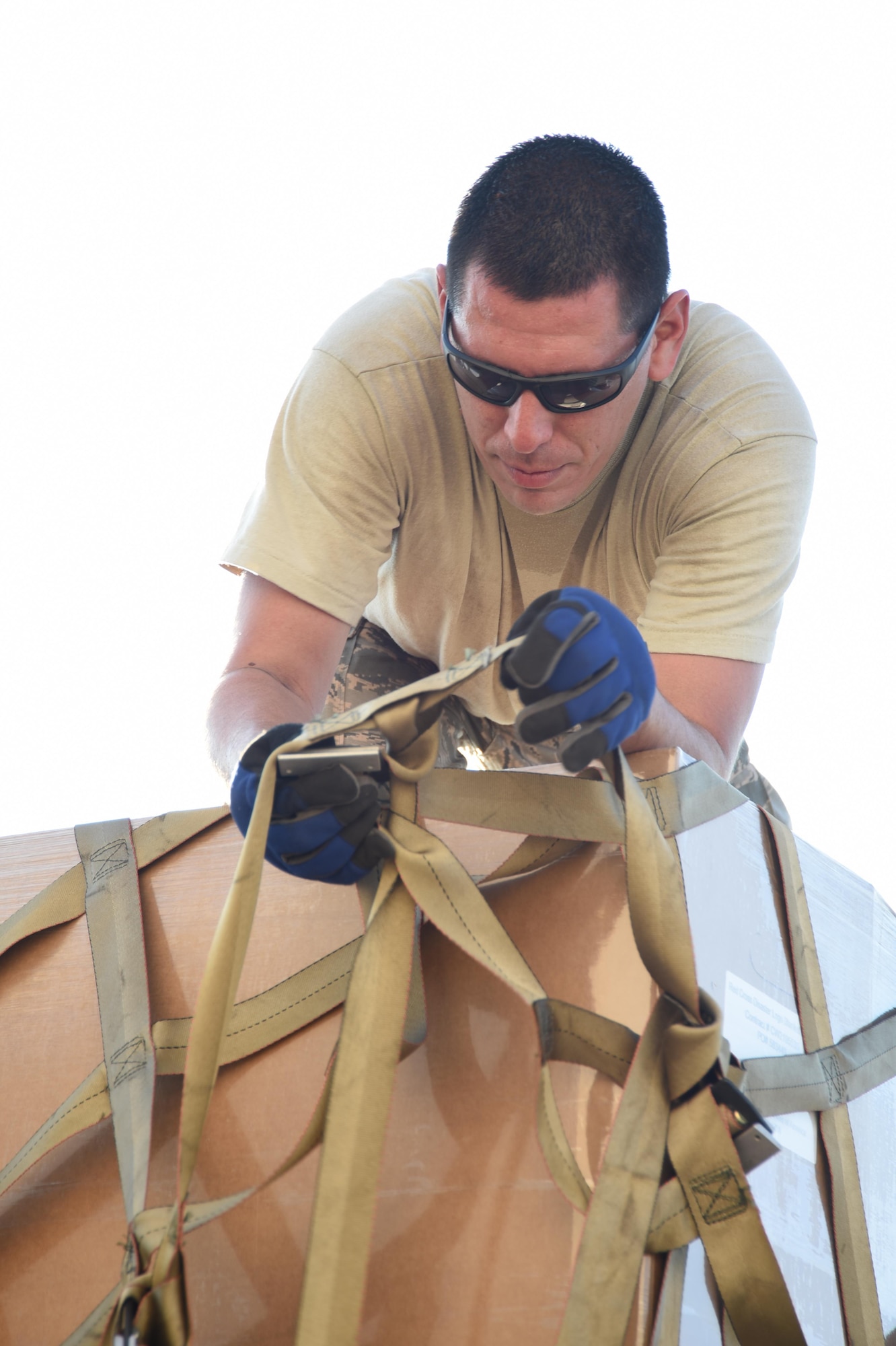 Air Force Tech. Sgt. Lucas Ortega, 73rd Aerial Port Squadron cargo supervisor, adjusts webbing on a pallet used to secure American Red Cross supplies before their transport August 29, 2017, at Naval Air Station Fort Worth Joint Reserve Base, Texas, in support of Hurricane Harvey relief efforts. There were 90,000 lbs. of supplies, included blankets and cots, sent as part of the Defense Support of Civil Authority. Department of Defense provides medium and heavy lift rotary wing assets, along with ground transportation, to move personnel, commodities and equipment within Texas. (U.S. Air Force photo by Ms. Julie Briden-Garcia)