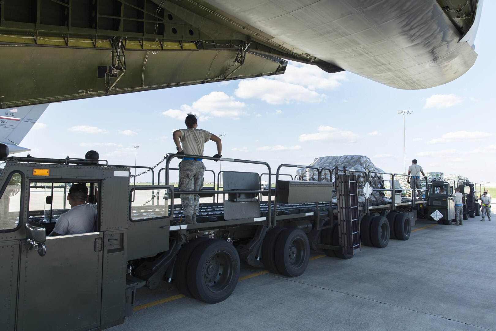 U.S. Air Force Personnel with 502nd Logistics Readiness Squadron load supplies and equipment on a military aircraft