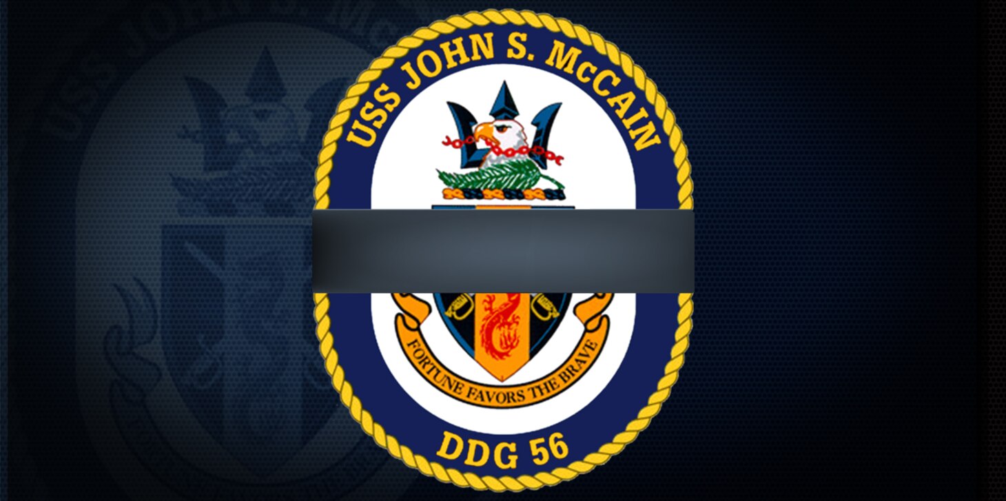 The crest of the guided-missile destroyer USS John S. McCain (DDG 56) modified with the traditional black ribbon signifying remembrance or mourning.