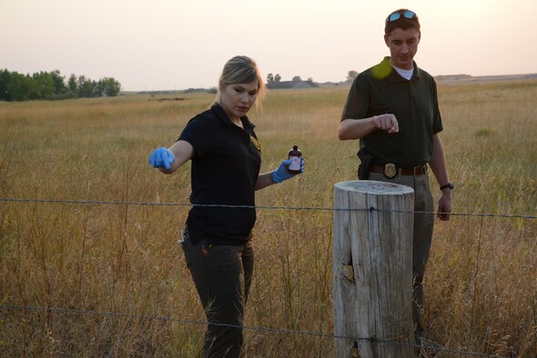 Special agents from the Office of Special Investigations headquarters and Buckley Air Force Base, Colo., spread fake blood to simulate a crime scene for a training exercise Aug. 29, 2017, at Malmstrom Air Force Base, Mont. The special agents guided public affairs photojournalists through crime scene processing and proper photo documentation. (U.S. Air Force photo/Staff Sgt. Delia Martinez)