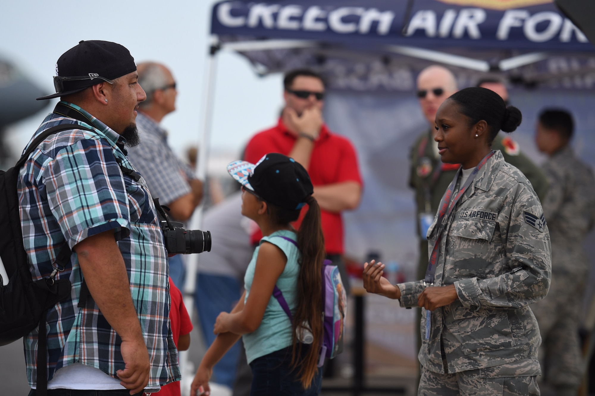 Senior Airman Tashiona, 432nd Wing intelligence analyst, explains her mission to a man attending the Thunder Over Dover Open House, Aug. 25, 2017, at Dover Air Force Base, Del.