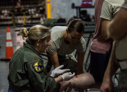 A medic from the 59th Medical Wing, Joint Base San Antonio-Lackland, Texas, assists a patient at the George Bush Intercontinental Airport in Houston, Texas, in response to the devastation caused by Hurricane Harvey, August 30, 2017. The 59th MDW is part of a larger Department of Defense presence in an effort to aid eastern Texas following a record amount of rainfall and flooding. (U.S. Air Force photo/Senior Airman Stefan Alvarez)
