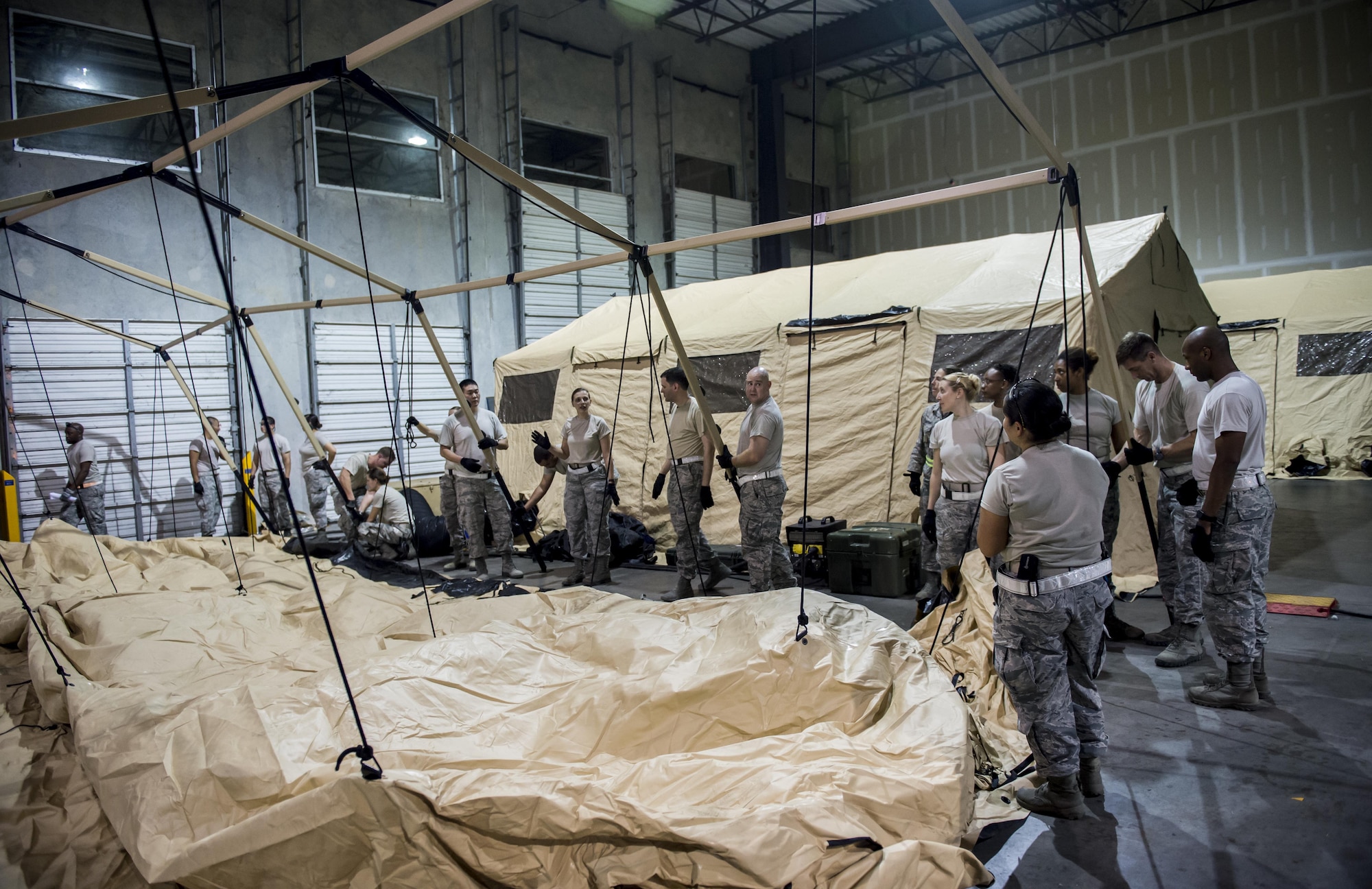 Personnel from the 59th Medical Wing, Joint Base San Antonio-Lackland, Texas, set up a medical tent inside a hangar at the George Bush Intercontinental Airport in Houston, Texas, during relief efforts following the devastation caused by Hurricane Harvey, August 30, 2017. The 59th MDW is part of a larger Department of Defense presence in an effort to aid eastern Texas following a record amount of rainfall and flooding. (U.S. Air Force photo/Senior Airman Keifer Bowes)