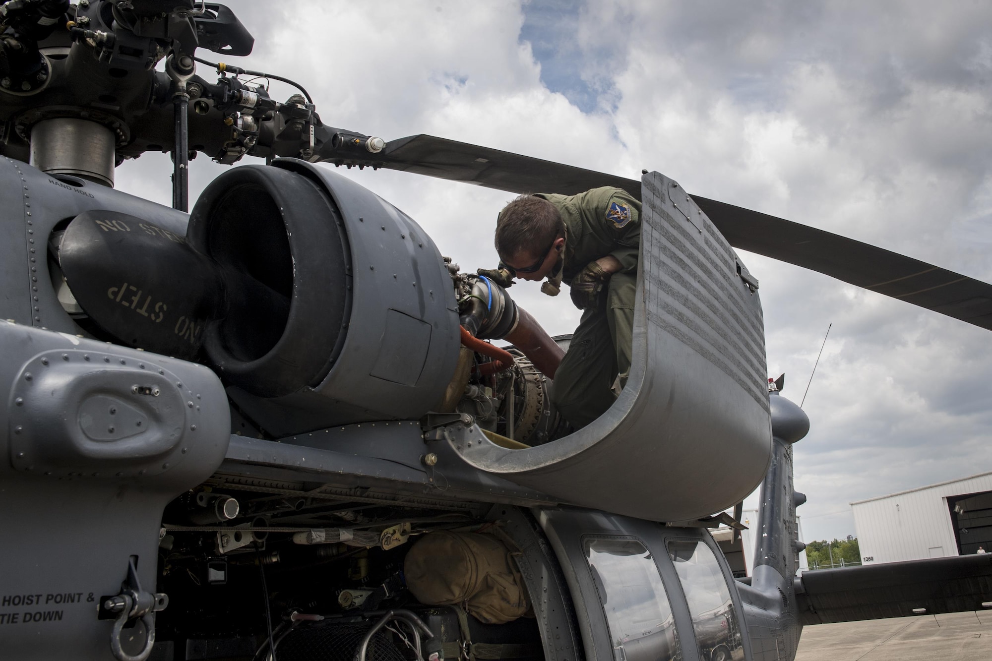 A special missions aviator from the 41st Rescue Squadron, inspects an engine on an HH-60G Pave Hawk, Aug. 30, 2017, at Easterwood Airport in College Station, Texas.