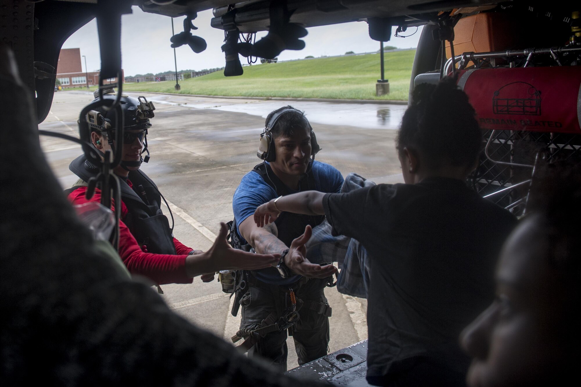 Pararescuemen from the 38th Rescue Squadron unload evacuees from an HH-60G Pave Hawk, Aug. 30, 2017, in the Houston, Texas area.