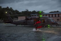 A Pararescueman from the 38th Rescue Squadron carries a basket to help move an evacuee, Aug. 30, 2017, in the Houston, Texas area.
