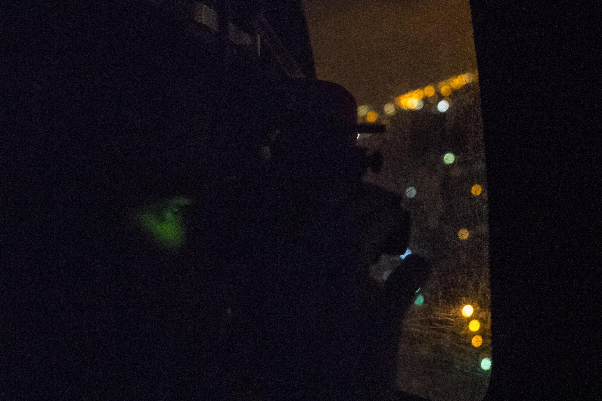 A Pararescueman from the 38th Rescue Squadron scans the ground with night vision for those that might need evacuated, Aug. 30, 2017, in the Houston, Texas area.