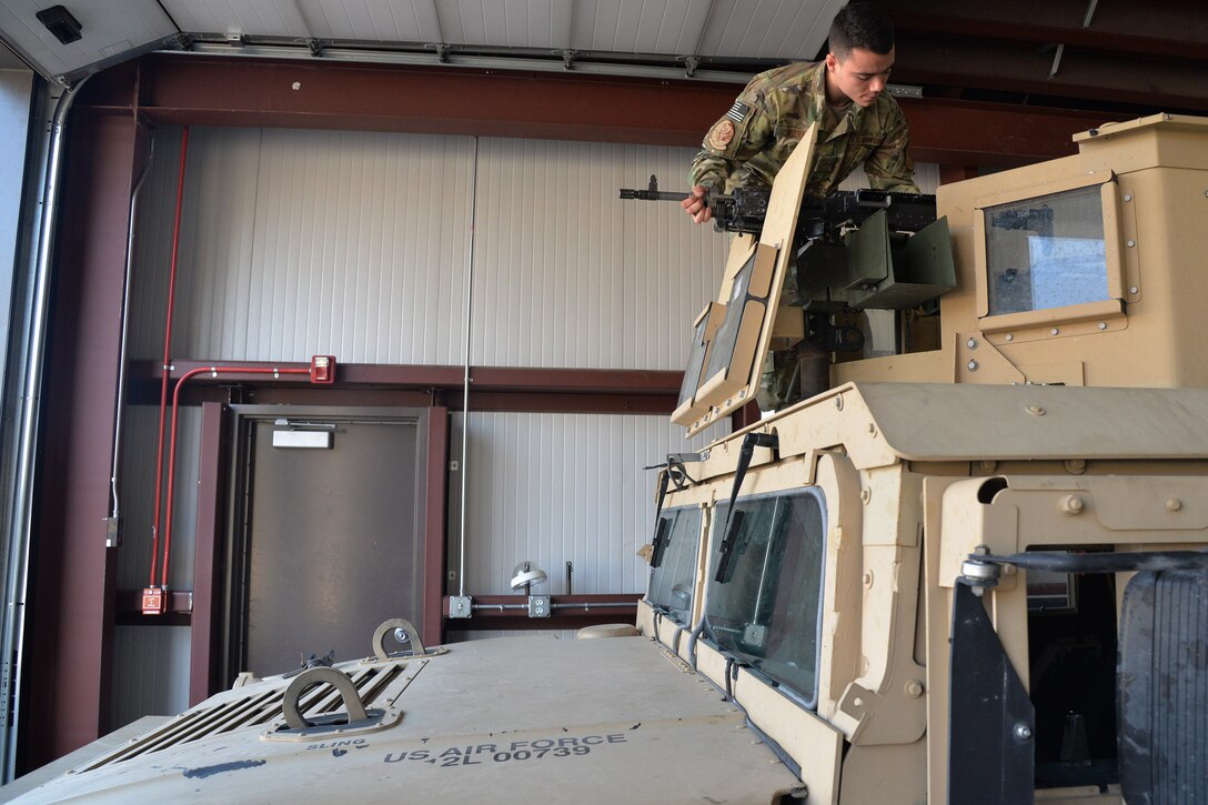 Airman 1st Class Dillan Caceres, 341st Missile Security Forces Squadron response force leader, places a weapon on a Humvee Aug. 28, 2017, near Belt, Mont.