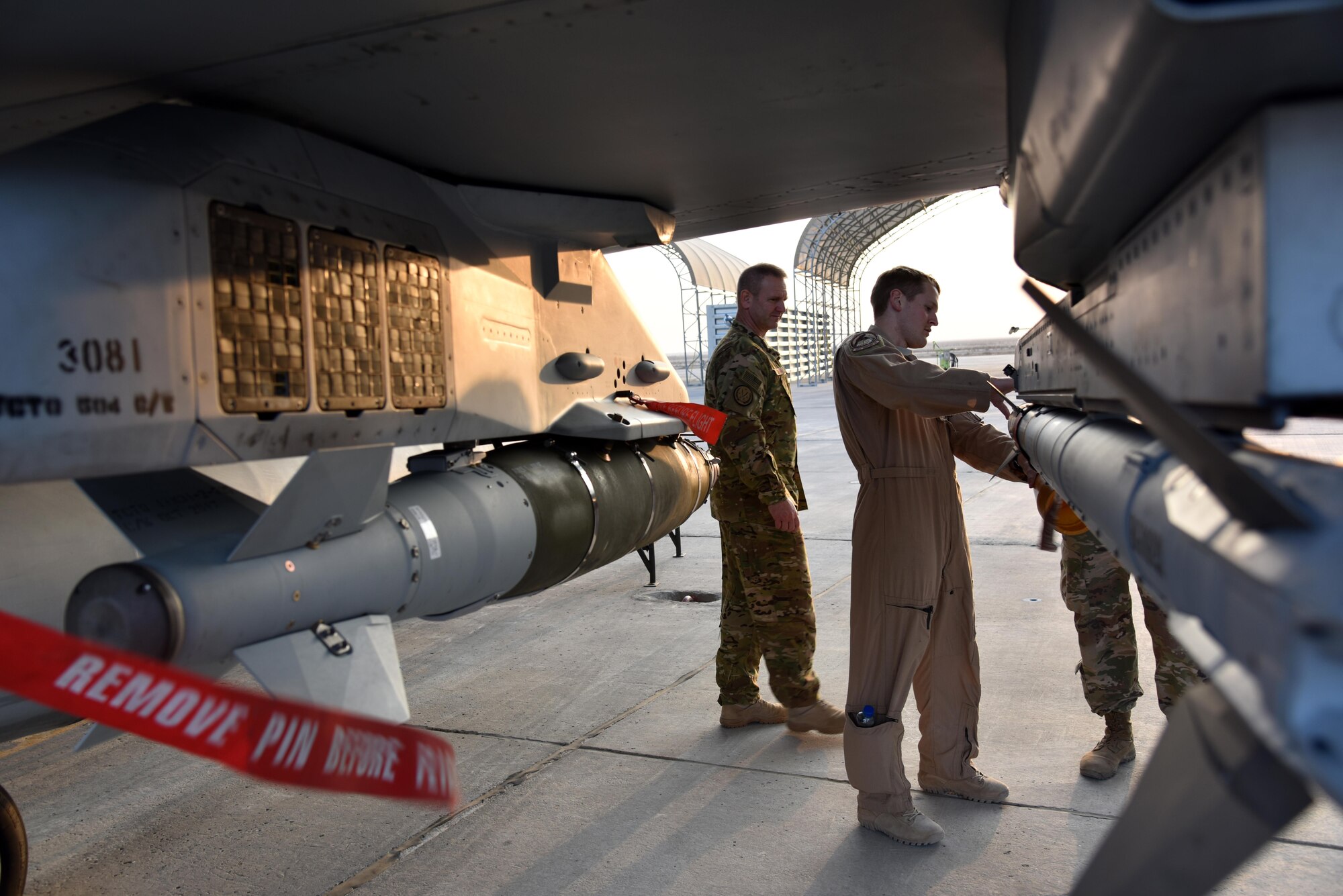 A U.S. Air Force captain, 100th Expeditionary Fighter Squadron pilot, explains the weapons systems of the 100th EFS’s F-16 Fighting Falcons to Maj. Gen. Dirk Smith, 9th Air Expeditionary Task Force-Levant Commander, at the 407th Air Expeditionary Group in Southwest Asia. Smith also viewed inside the F-16. (U.S. Air Force photo by Staff Sgt. Joshua Edwards/Released)