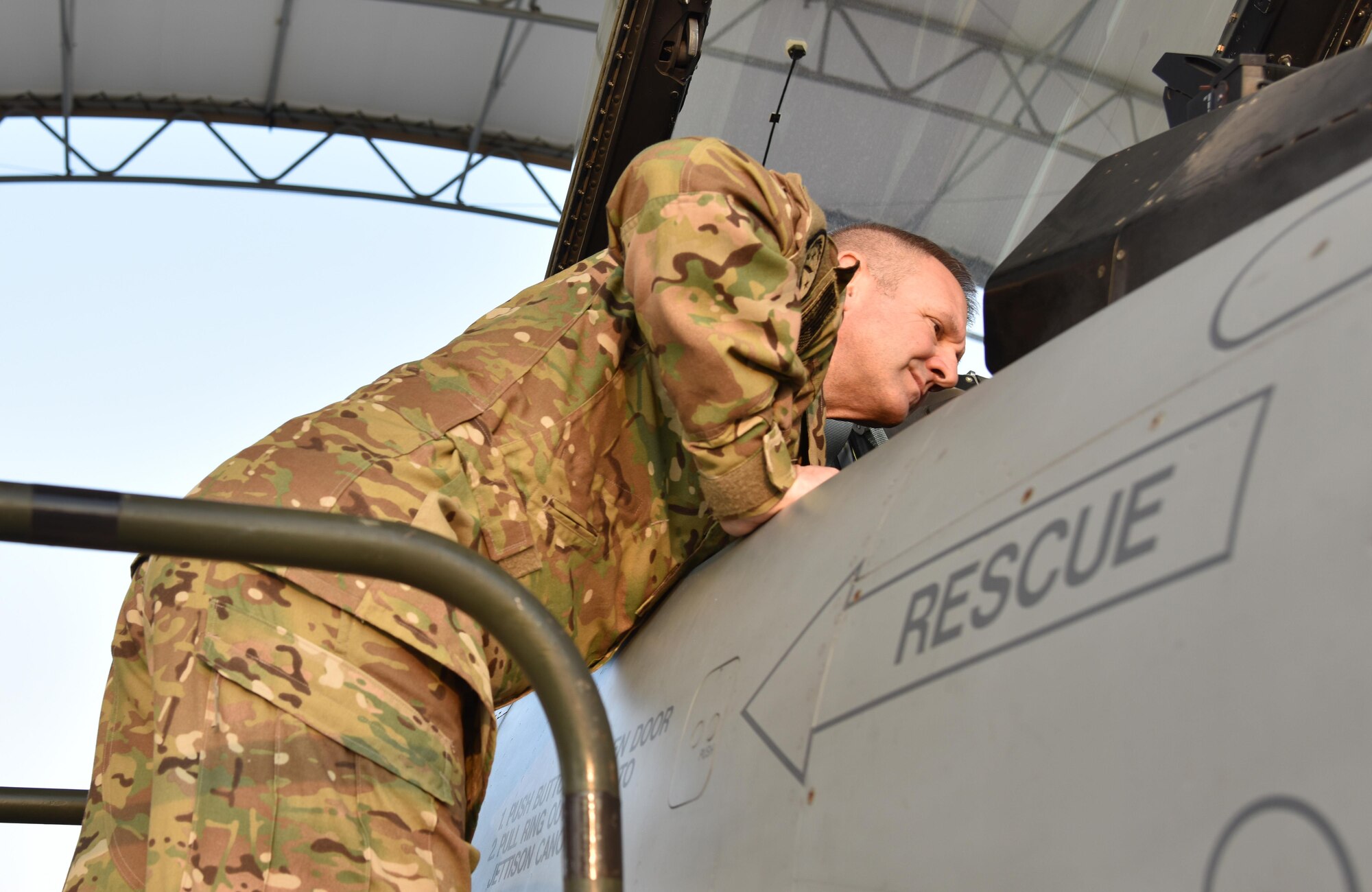 U.S. Air Force Maj. Gen. Dirk Smith, 9th Air Expeditionary Task Force-Levant Commander, inspects the inside of a 100th Expeditionary Fighter Squadron F-16 Fighting Falcon at the 407th Air Expeditionary Group in Southwest Asia, Nov. 29, 2017. During his visit, Smith also viewed the aircraft of sister services and coalition partners. (U.S. Air Force photo by Staff Sgt. Joshua Edwards/Released)