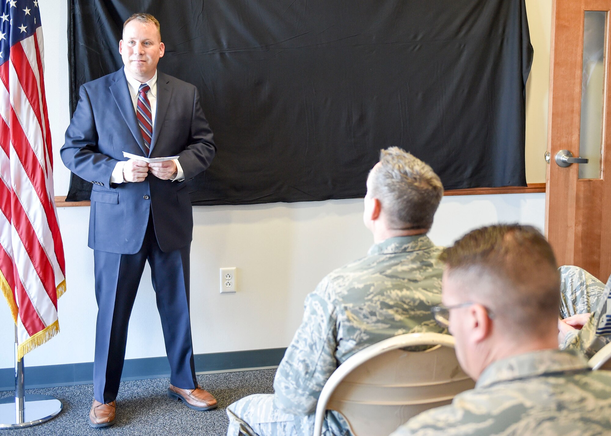 Special Agent John Driscoll, Air Force Office of Special Investigations (AFOSI) operating location chief here, gives opening remarks at a dedication ceremony for a memorial wall, Nov. 29, 2017