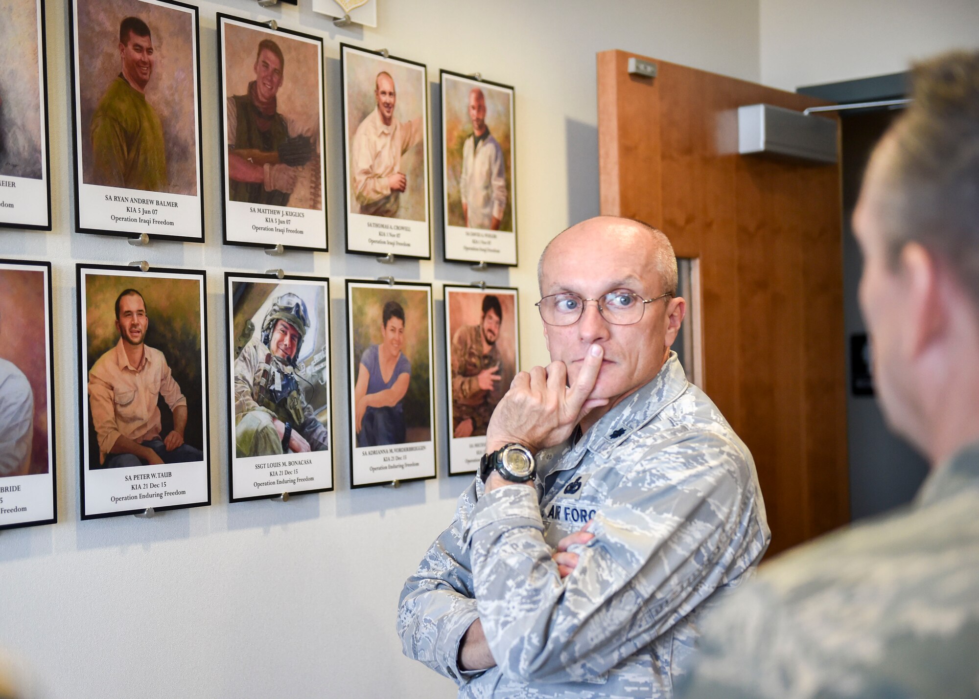 Special Agent John Driscoll, Air Force Office of Special Investigations (AFOSI) operating location chief here, gives opening remarks at a dedication ceremony for a memorial wall, Nov. 29, 2017