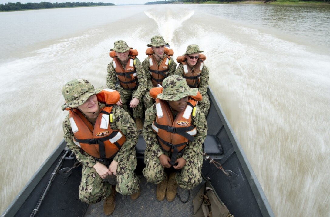 A team of five U.S. Navy doctors travel in a boat to a remote village along the Amazon River in Brazil.