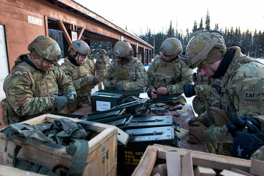 Airmen load M9 pistol magazines with 9 mm ammunition during a break in small-arms training at Joint Base Elmendorf-Richardson, Alaska.