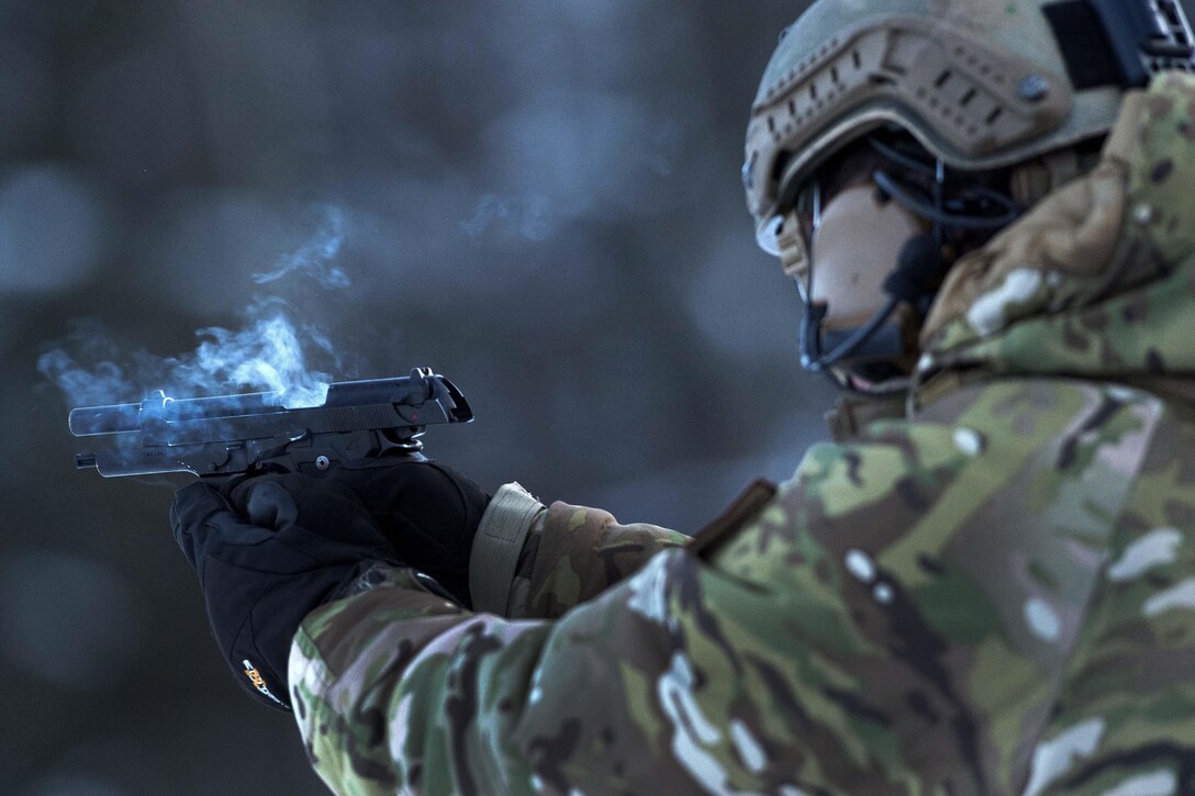 Smoke emanates from Air Force Staff Sgt. Nicolas Strickler’s M9 pistol during small arms training.