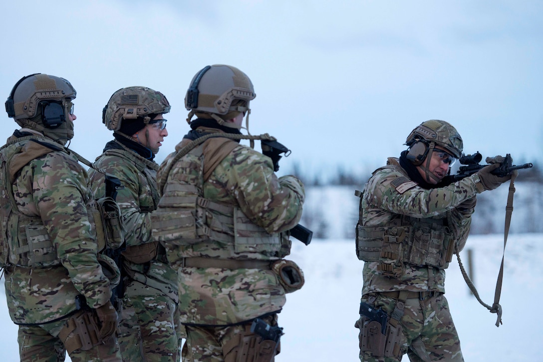 Senior Airman Daniel Gonzales, right, demonstrates an M4 carbine drill during training.