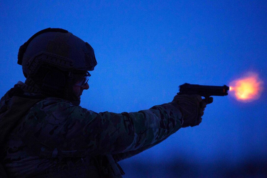 An airman fires an M9 pistol during small-arms training.