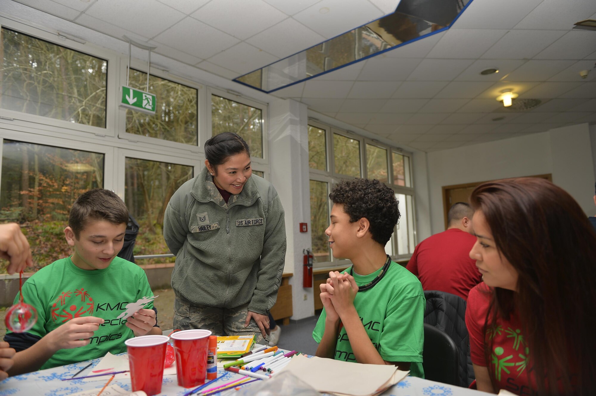 U.S. Air Force Kristina Hailey, 86th Dental Squadron non-commissioned officer in charge of the instrument processing center, talks to participants during the Kaiserslautern Military Community Winter Special Olympics on Vogelweh Military Complex, Germany, Dec. 1, 2017. The purpose of the Special Olympics events are to help build self-confidence and camaraderie in the children who participate. (U.S. Air Force photo by Airman 1st Class Joshua Magbanua)