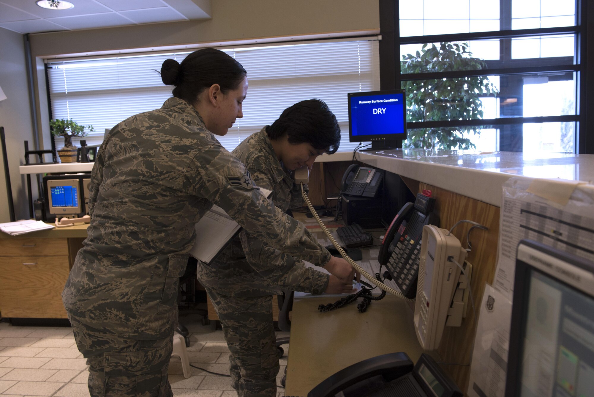 From Left to Right, Airman 1st Class Sabrina Watson and Maritza Rivera, 366th Operations Support Squadron airfield management coordinators, practice an exercise training situation Nov. 30, 2017, at Mountain Home Air Force Base, Idaho. The airfield management team's main priority is safety for crewmembers and aircraft. (U.S. Air Force photo by Senior Airman Lauren-Taylor Levin)