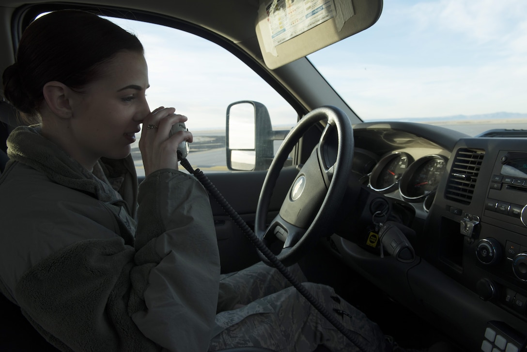 Staff Sgt. Gabrielle Swift, 366th Operations Support Squadron airfield management operations supervisor, calls the air traffic control tower for clearance to cross the runway Nov. 30, 2017, at Mountain Home Air Force Base, Idaho. Swift and others from the airfield management team do daily checks for wildlife on the runway, cracks in the pavement and debris that could cause damage to aircraft. (U.S. Air Force photo by Senior Airman Lauren-Taylor Levin)