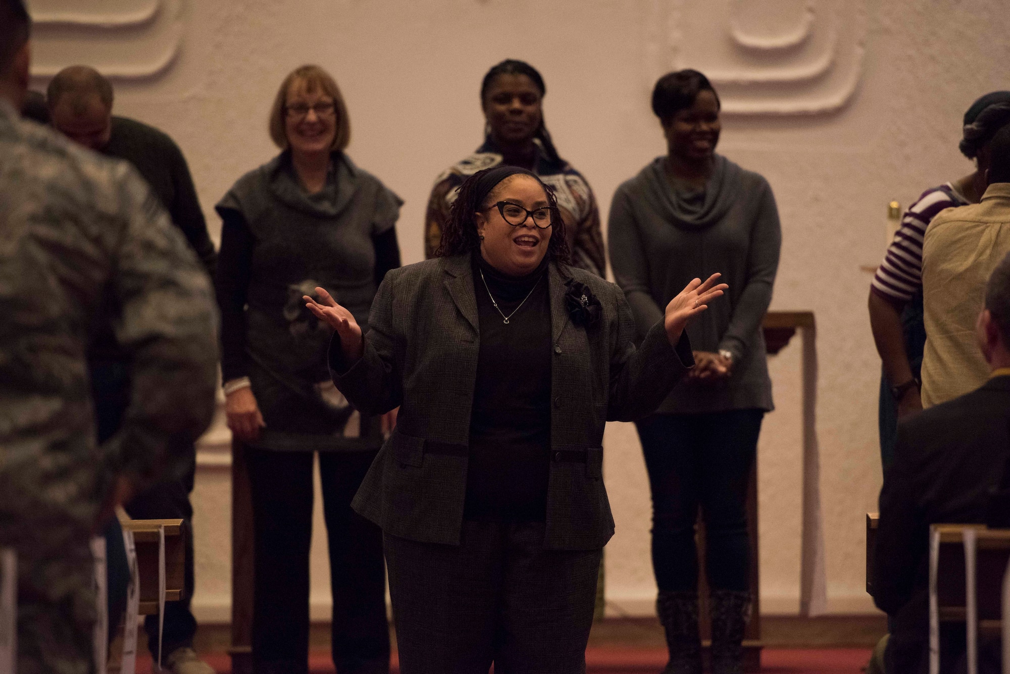 A member of the Ramstein combined choir speaks during the base Christmas tree lighting ceremony at Ramstein Air Base, Germany, Nov. 29, 2017. The choir sang Christmas carols before proceeding to the lighting of the base tree. (U.S. Air Force photo by Airman 1st Class Devin M. Rumbaugh)