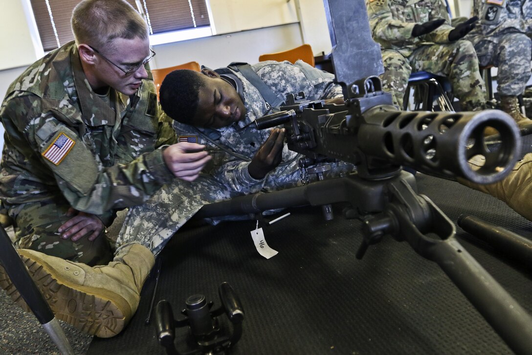 Solders assemble a machine gun.