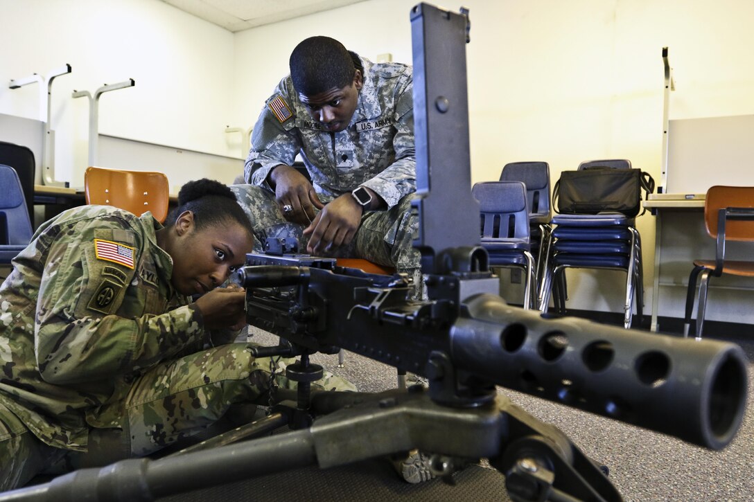 Army Reserve Spc. Ashley Taylor, left, and Spc. Dashon Moore assemble an M2 machine gun as part of primary marksmanship instruction during Operation Cold Steel II.