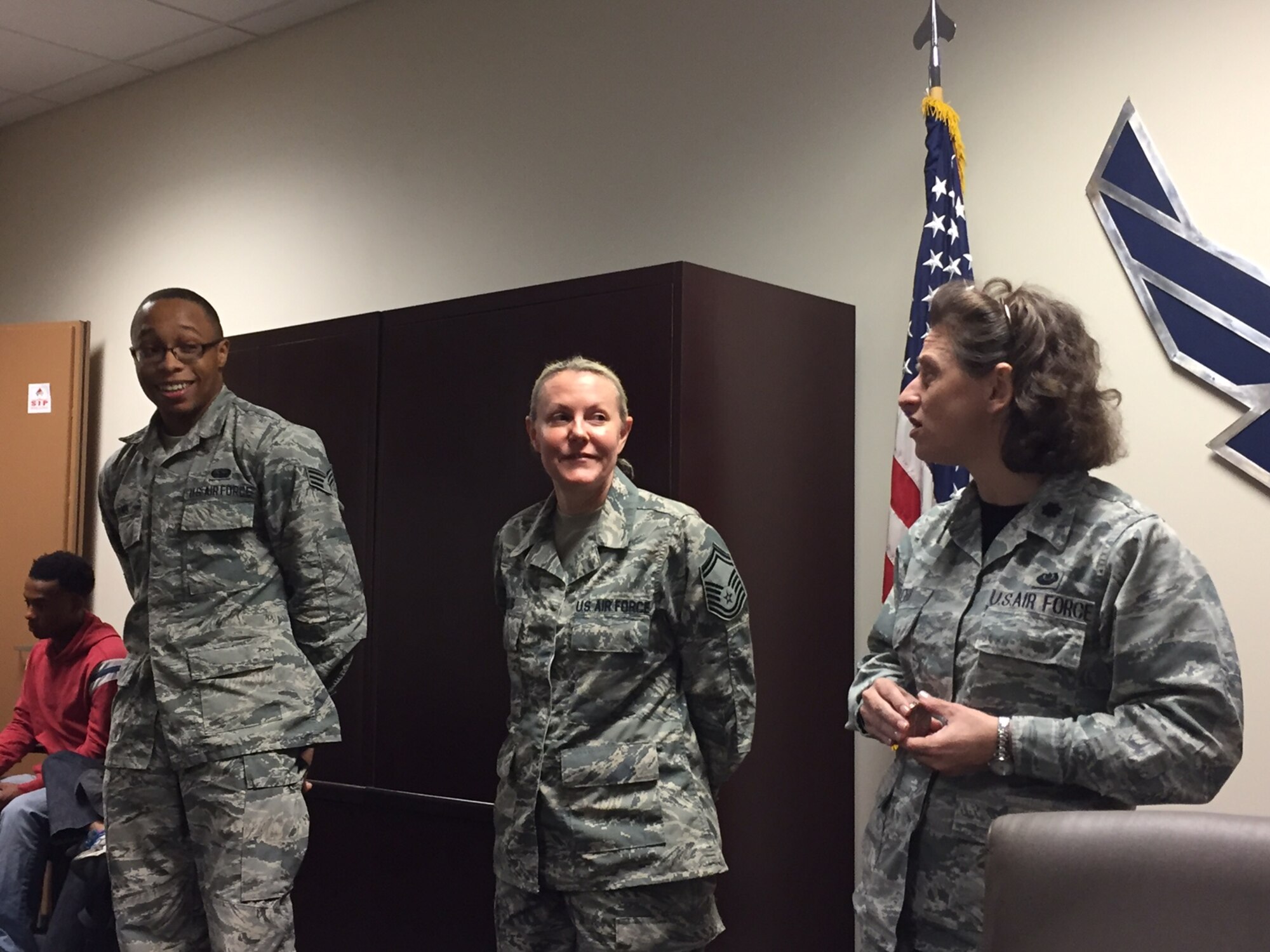 Lt. Col. Eddyth Cobb, 403rd Wing Judge Advocate, presents Peer to Peer coins to Senior Airman Treviant Evans and Senior Master Sgt. Carrie Meyls, 403rd Communications Flight, Oct. 15, 2017 at Keesler Air Force Base, Mississippi. Cobb presented the coins because Evans and Meyls helped her troubleshoot and correct an issue with her laptop that prevented her from accessing the government laptop she needed while at home in a different state. (U.S. Air Force photo by Staff Sgt. Heather Heiney)