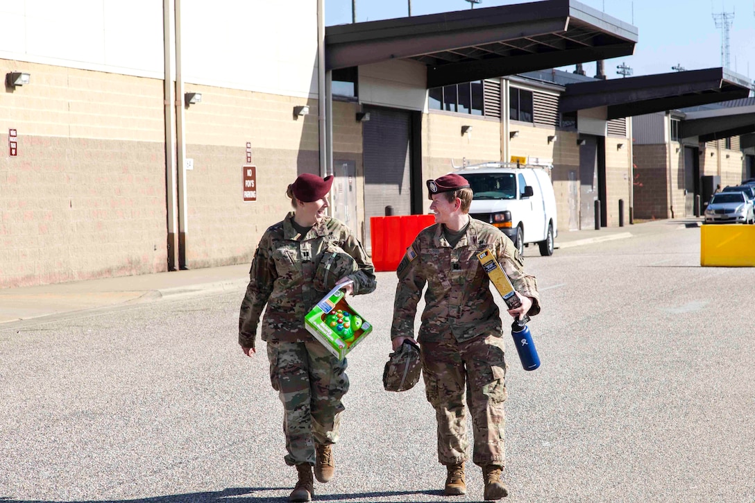 Soldiers share a moment before donating toys for the 20th Annual Randy Oler Memorial Operation Toy Drop at Fort Bragg, N.C.